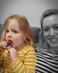 Small girl eating. 
Filtered photo of mum